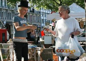 Shopper carries plastic bags at a flea market in Geneva, Switzerland, 2006. (Photo by