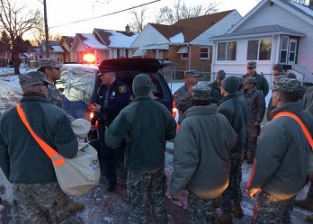 Michigan National Guard members go door to door to deliver water, filters, replacement cartridges and water test kits to residents of Flint, Michigan on January 19, 2016. (Photo by U.S. National Guard Maj. Joe Cannon)