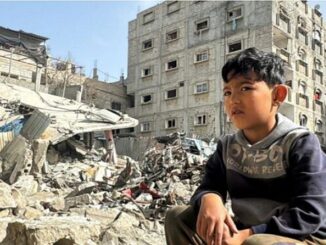 boy and bombed buildings Gaza
