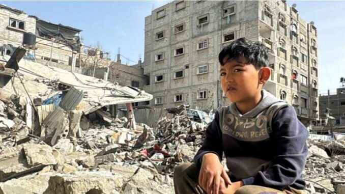 boy and bombed buildings Gaza